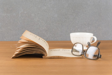old book with glasses and a cup of coffee