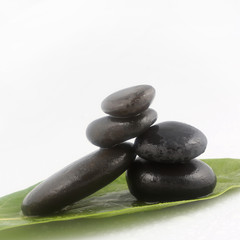 Balanced black zen stones on white background
