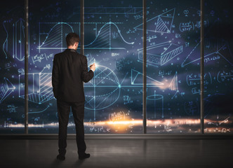 Businessman drawing business graphs