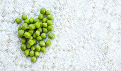 Green peas on the vintage linen background