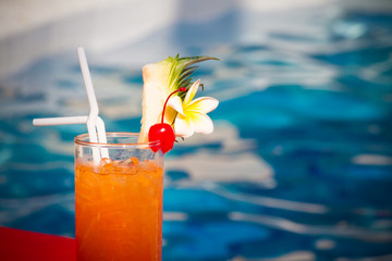 orange mojito cocktail by the pool