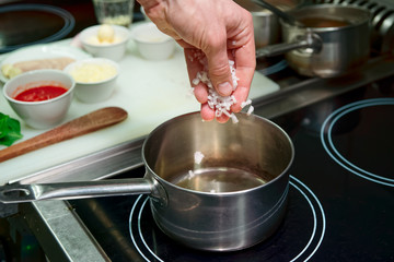 Chef is frying onion to make risotto