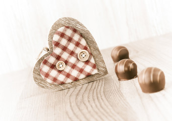 Chocolate truffle and a wooden heart