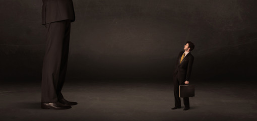 Obraz premium Huge man with small businessman standing at front concept