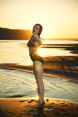 Fototapeta na wymiar Beautiful woman in bikini on sunset background