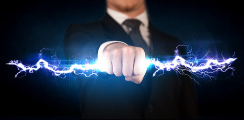 Business man holding electricity light bolt in his hands
