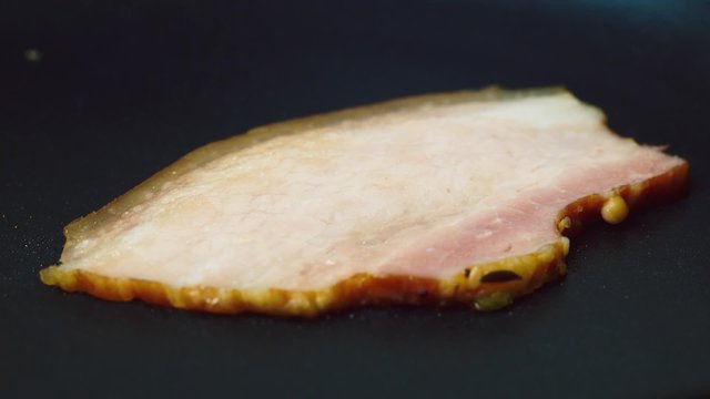 Bacon frying in a pan