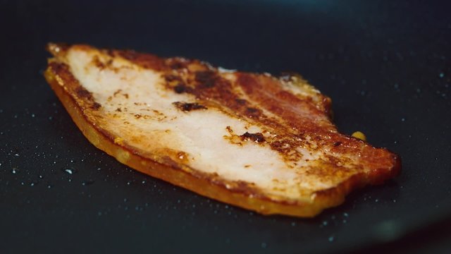 Bacon frying in a pan