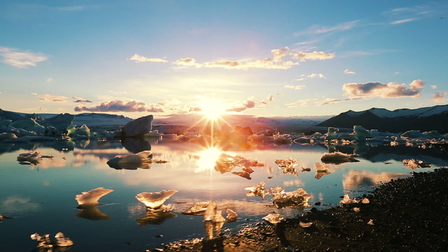 Drifting Icebergs Broken from Glaciers in Iceland. Amazing Sunrise.
