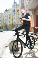 Cheerful young hipster guy got lost on street