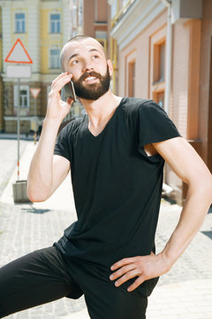 Handsome young man with beard in city