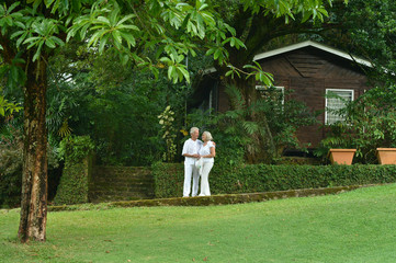 Elderly couple  in tropical garden