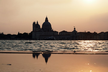 Fototapeta na wymiar Sunset in Venice - Reflection of the Madonna della Salute church