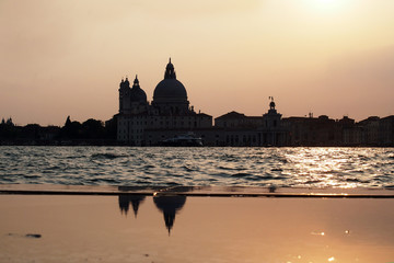 Fototapeta premium Sunset in Venice - Reflection of the Madonna della Salute church