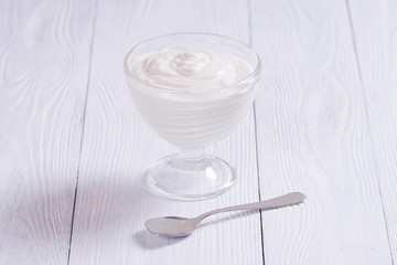 Grechisky yogurt in a glass bowl on a white background