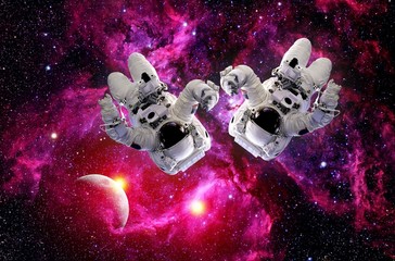 Two astronauts spacemen suit outer space planet gravity universe. Elements of this image furnished by NASA.