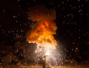 Realistic fiery explosion busting over a black background