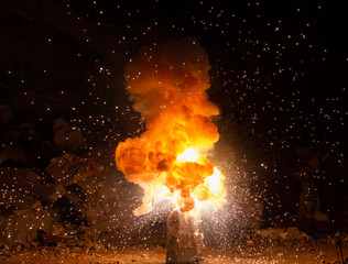 Realistic fiery explosion busting over a black background - obrazy, fototapety, plakaty