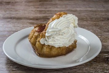 Savarin with whipped cream placed on a plate