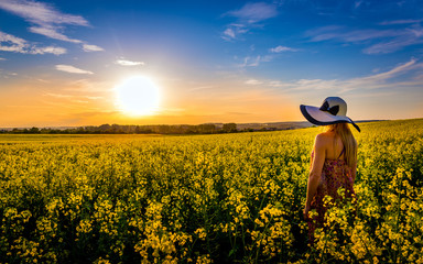 Woman on a field of yellow rape