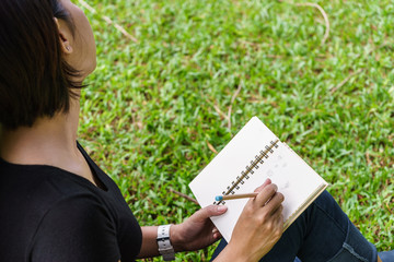 Asian girl's hand ready to write something on notebook