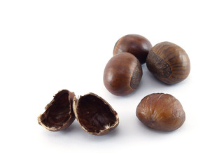 close up four chestnuts and nutshell isolated on white background, dark brown roasted chestnut are an Asian snack