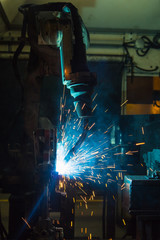 robots welding in a car factory