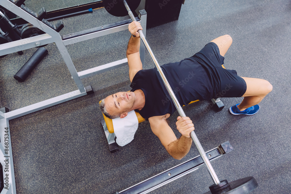 Canvas Prints Man with barbell on a bench press training