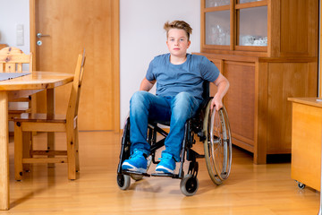 disabled boy in wheelchair at home