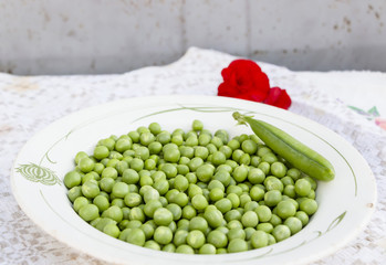 Green peas on the white plate background