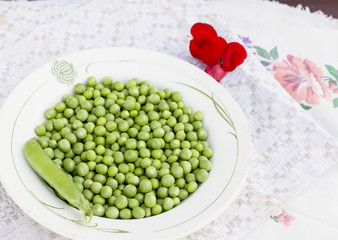 Green peas on the white plate background