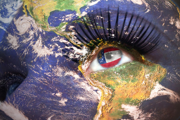 womans face with planet Earth texture and georgia state flag inside the eye.