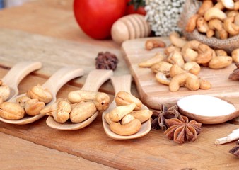 Roasted cashews nuts with natural on wood background