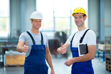 two worker in factory with thumb up