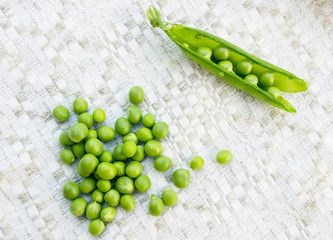 Green peas on the vintage linen background