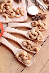 Roasted cashews nuts with natural on wood background