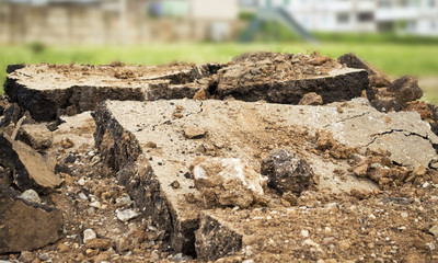 the pieces of the shattered concrete in the middle of the city