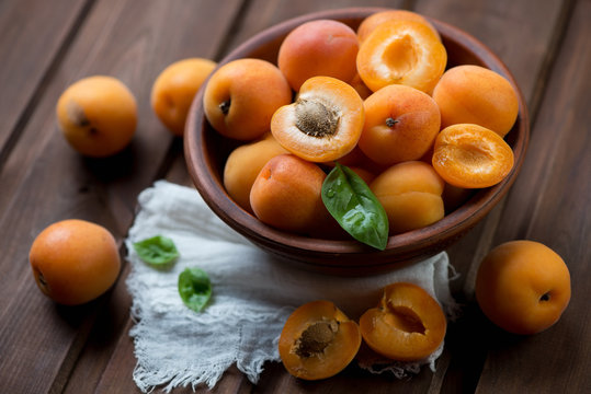 Ripe organic apricots in a ceramic bowl, close-up, studio shot