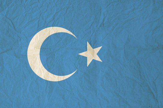 Flag of Xinjiang Uyghur with vintage paper texture