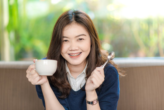 Young Business asian smiling woman Having a Coffee Break.  Close
