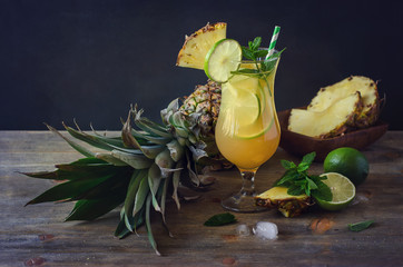 Cold refreshing pine apple cocktail drink with lime,  mint and i