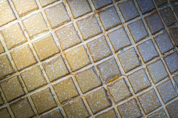 old grunge tile floor background texture with light from corner