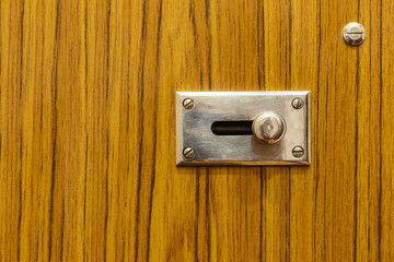 Metal latch on wooden door