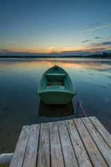 Foto auf Leinwand Beautiful lake sunset with fisherman boats © milosz_g