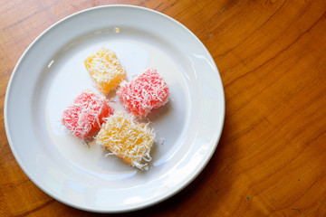 Thai dessert steam-minced cassava with shredded coconut on white dish