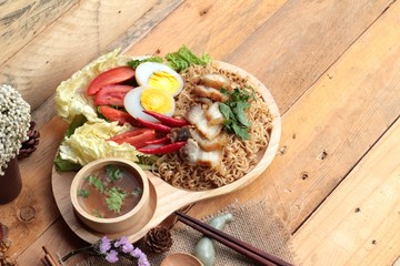 Instant noodles soup put crispy pork and egg