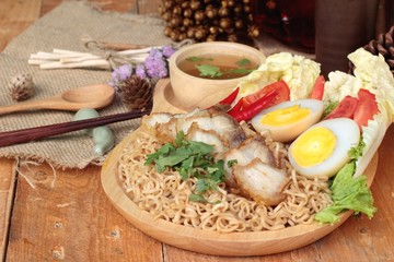Instant noodles soup put crispy pork and egg