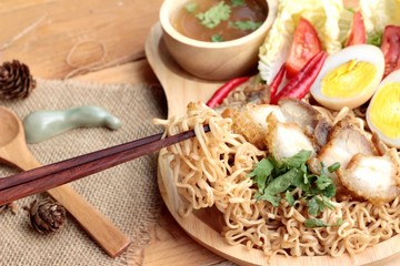 Instant noodles soup put crispy pork and egg