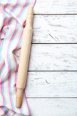 Empty wooden table with rolling pin and napkin on white backgrou