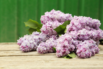 Beautiful lilac on grey wooden background